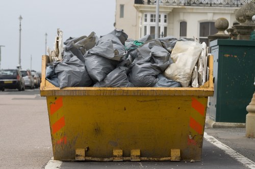 Recycling containers labelled for paper, plastics and food waste in a commercial yard